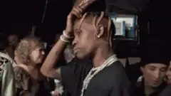 Travis Scott hand on head