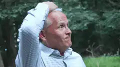 Man scratching head in frustration