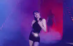Woman dancing in club with shadow