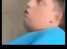 Man in blue shirt looking shocked