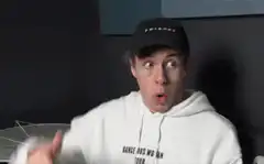 Guy in white hoodie and black cap making surprised face