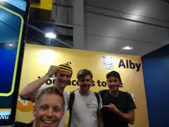 Four men posing at Alby booth