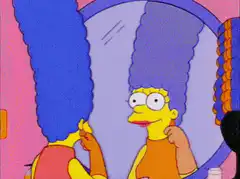 Marge Simpson admiring her hair in the mirror