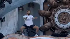 Man in white shirt dancing on stage