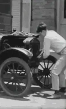 Man kicks old car tire
