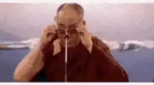 Dalai Lama puts on glasses