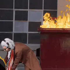 Ben Franklin throws a flaming Xbox into a dumpster