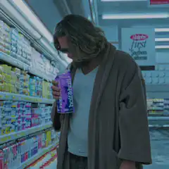 The Dude holding half and half in the grocery store