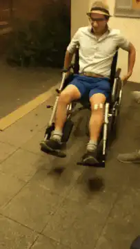 Man in wheelchair does a wheelie
