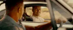 Two cars driving on a desert road