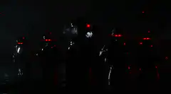 Soldiers illuminated by fire at night