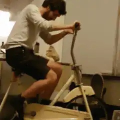Man on exercise bike falls over