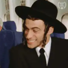 Smiling Hasidic Man on Plane