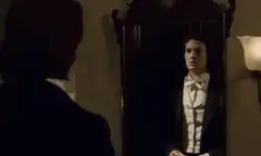 Dorian Gray looks in the mirror