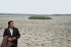 Man standing in cracked desert