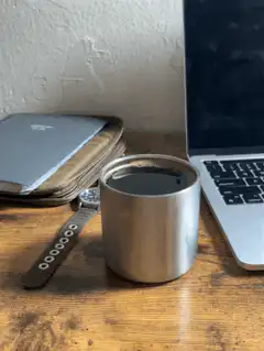 coffee cup on desk next to laptop