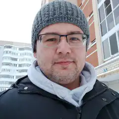 Man in grey beanie and glasses