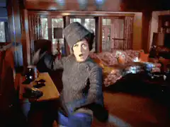 Woman in hat dancing in living room