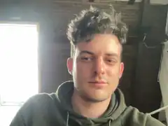 Man with messy hair looking at camera