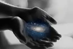 Hands holding a galaxy