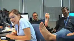 Woman reacts to smelly feet in office
