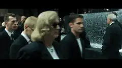 Trinity in red dress at Neo's funeral