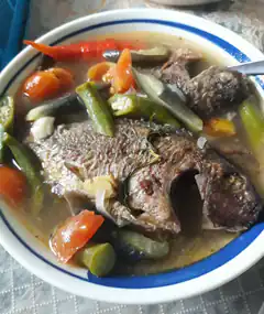 bowl of fish soup with vegetables