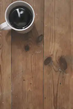 top-down view of coffee cup on wood