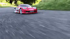Red RC car drifting on track