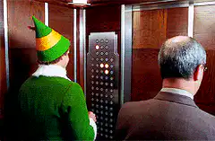 Buddy the Elf pressing elevator buttons