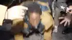 Man in yellow jacket gets up from ground