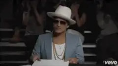 Bruno Mars and Anderson .Paah holding up 10 scorecards