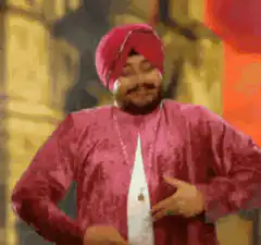 Man in pink turban pointing at himself