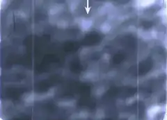 White arrow pointing down on cloudy background