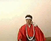 man in red robe with kanji