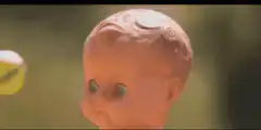 Doll head eats tennis ball
