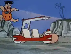 Fred Flintstone driving his car