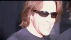 Tom Cruise and John Travolta smiling in sunglasses