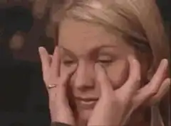 Woman rubbing eyes tired