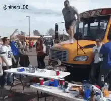 Man jumps off school bus onto table