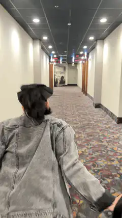 person running down hotel hallway