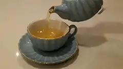 pouring tea into a cup