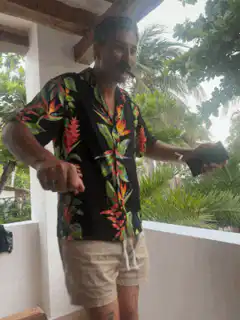 Man in Hawaiian shirt dancing on balcony