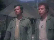 Two men salute each other
