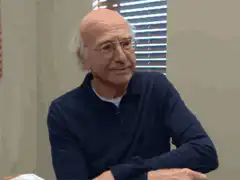Larry David squinting and grimacing