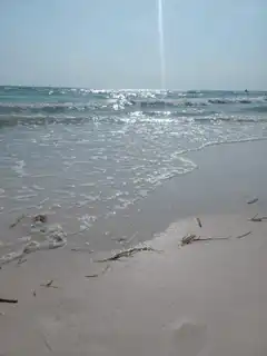 Ocean waves washing up on a sandy beach