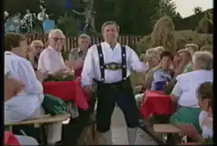 Man in lederhosen dancing at beer garden