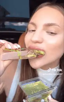 Woman eating green chocolate bar