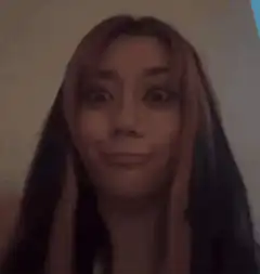 woman pointing at her eyes