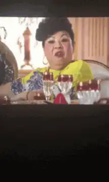 Asian woman at dinner table gestures